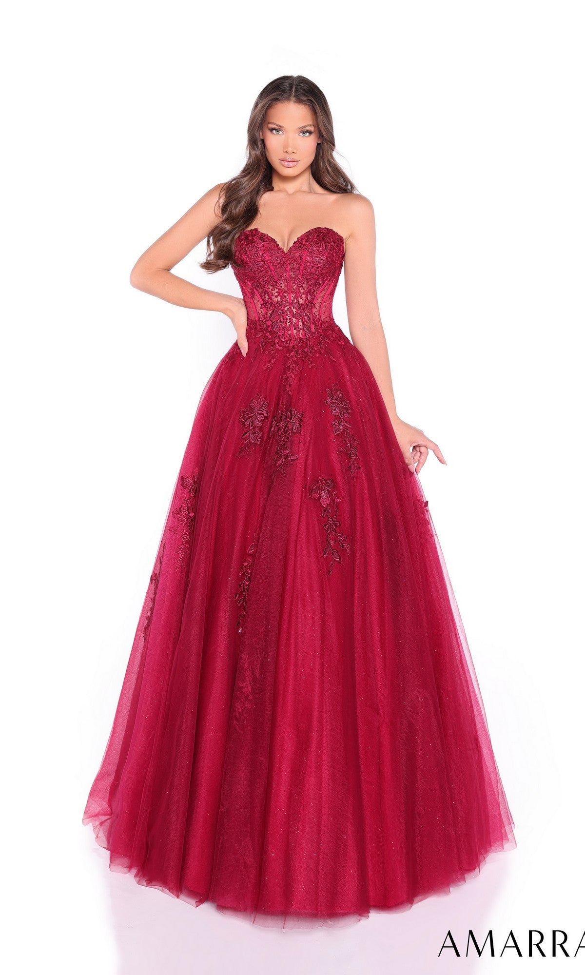 A woman models the Amarra 89011 Lace-Up Strapless Prom Ball Gown, featuring a sweetheart bodice with lace and sequin embellishments, standing against a white background.